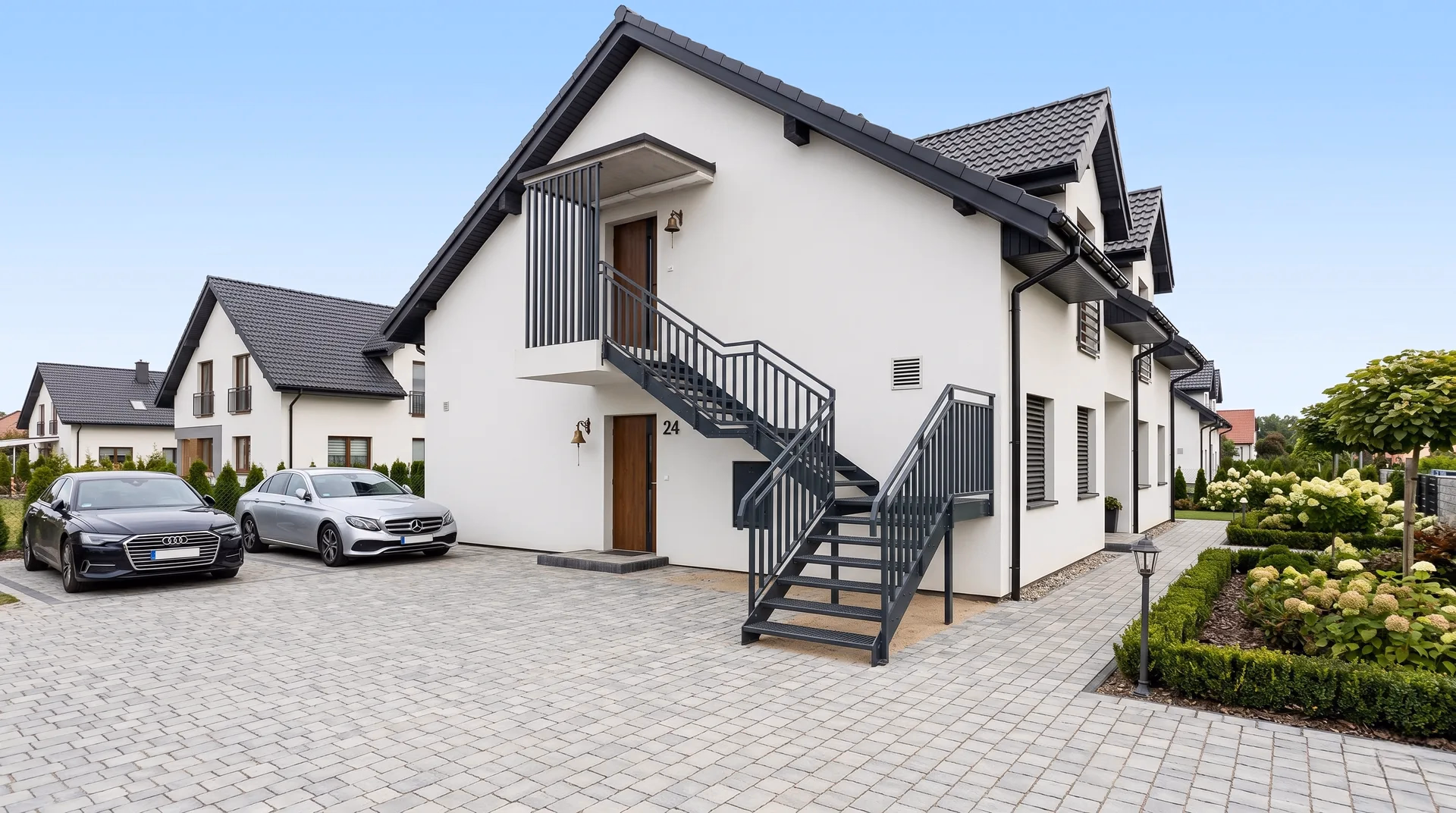 Treppengeländer aus Stahl mit vertikalen Stäben in Anthrazit an kompakter Außentreppe am Mehrfamilienhaus in Magdeburg